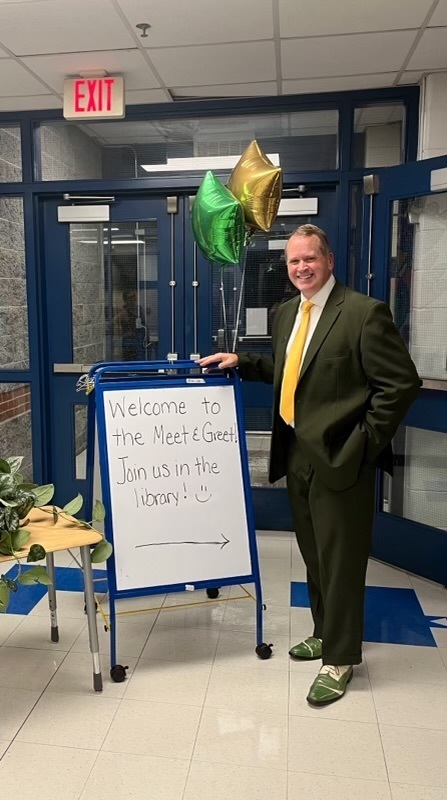 Mr. Runey at the welcome sign
